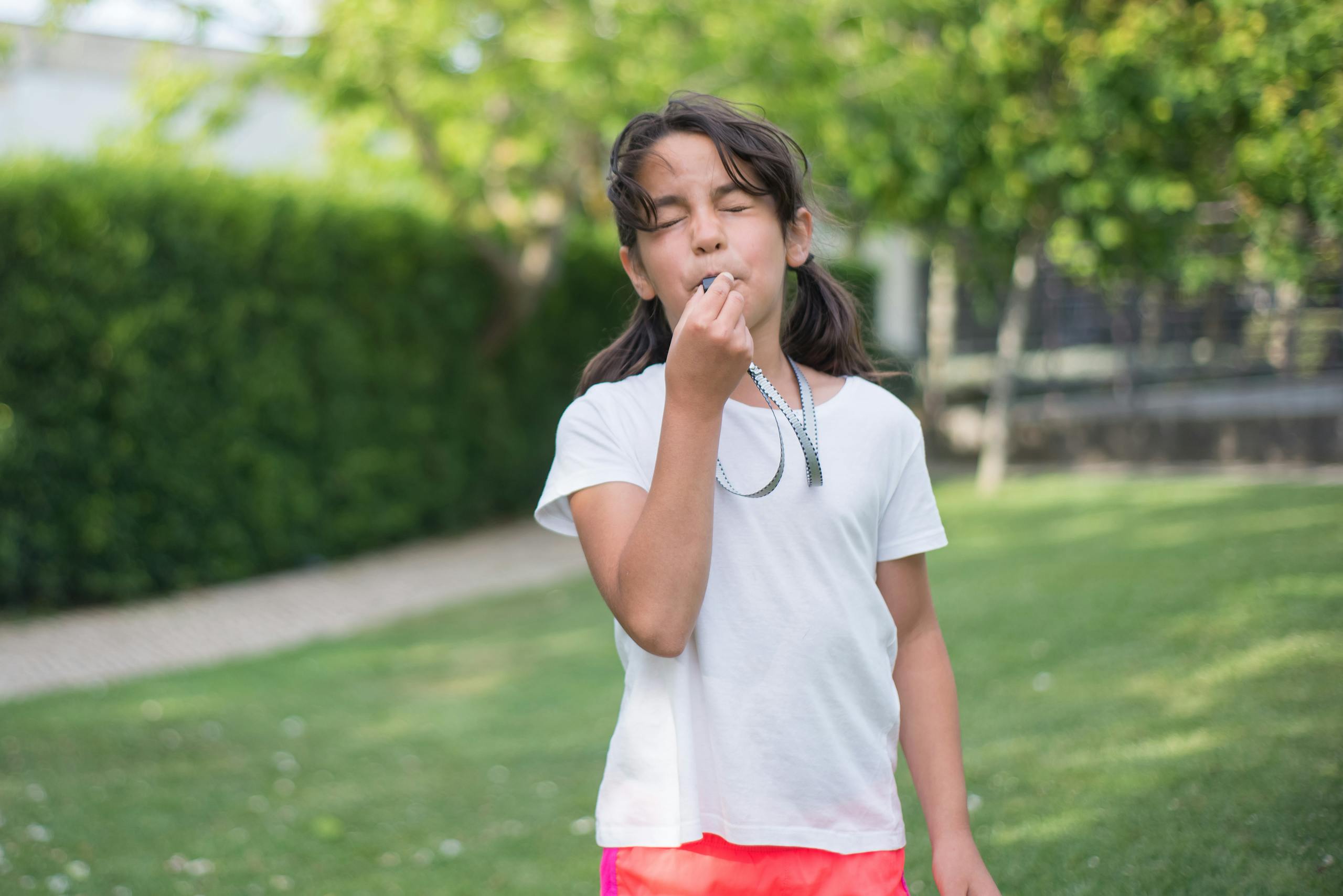 A Girl Blowing a Whistle